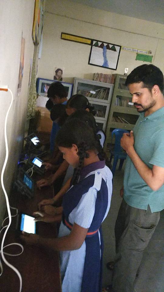 students using tablets in school library